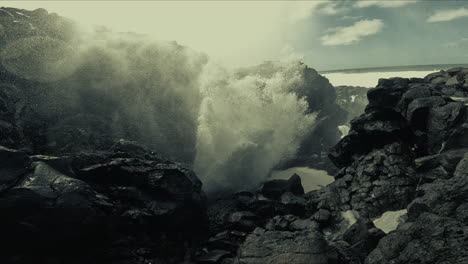 powerful ocean waves crashing against volcanic rocks