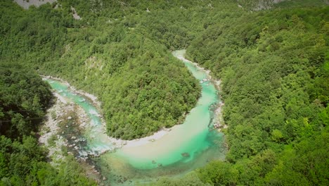 aerial view of the calm water surrounded by nature at soca river in slovenia.