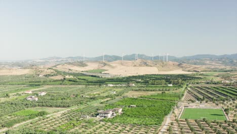 panoramic view of the calabria coastline, olives fields,agricultural fields and wind turbines in the background, calabria, italy