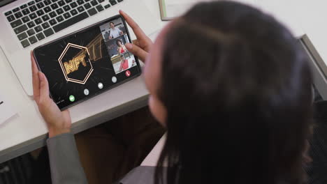 mujer de negocios biracial que usa una tableta para videollamadas con diversos colegas de negocios