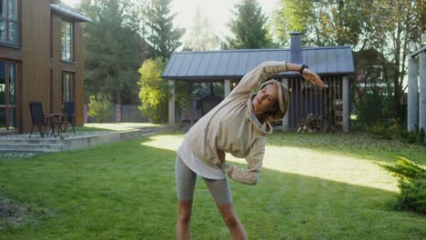 woman stretching in backyard