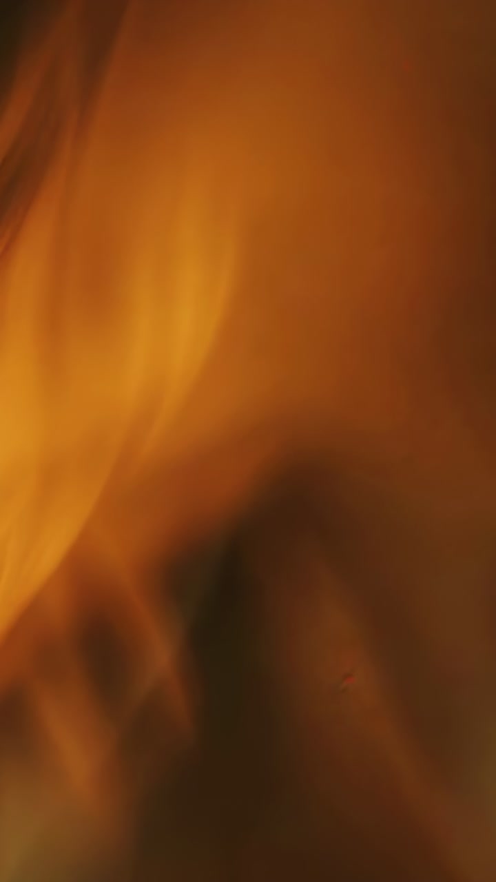 Vertical video: Abstract amber blur spreading across screen, creating warm and soothing atmosphere