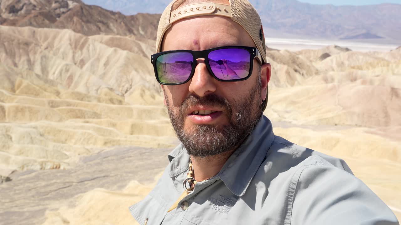 Man Explaining Vast Desert Landscape from Scenic Viewpoint