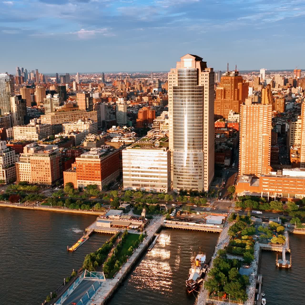 Beautiful bright New York panorama on sunny day. Drone footage approaching high building on the river waterfront