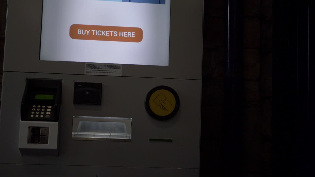 Self service ticket machines in train station panning shot