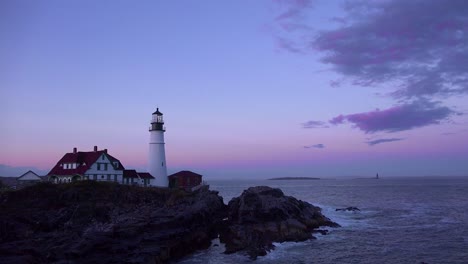 establishing shot of the portland head lighthouse in portland maine at dusk