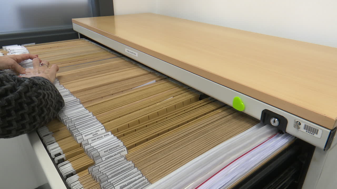 Woman organizing files in a filing cabinet