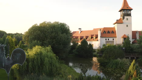 Weathercock-in-a-garden-with-a-pond-next-to-a-medieval-castle,Czechia