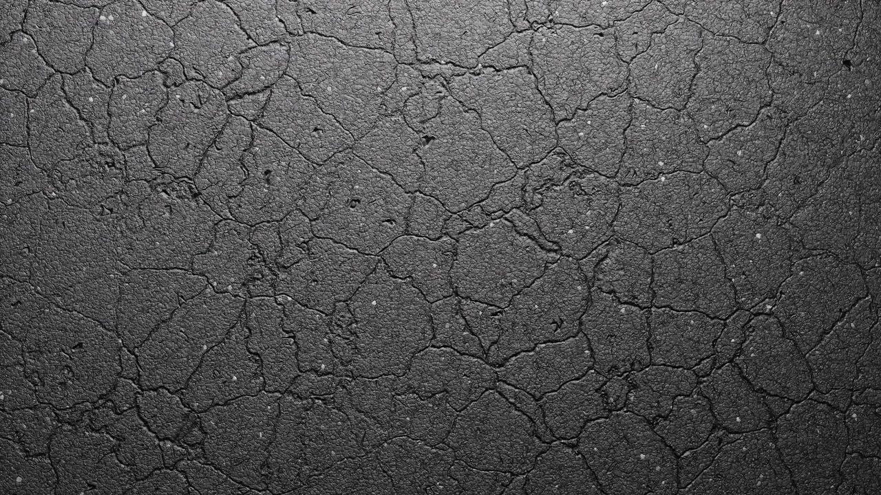 Close-up of Cracked Asphalt Surface Texture