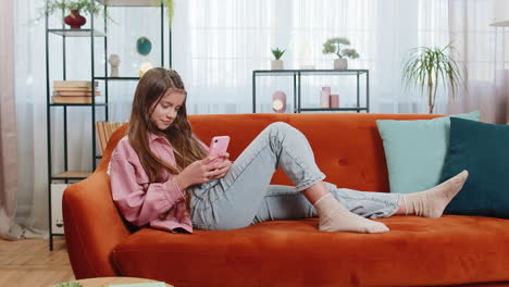 young girl texting share messages content on smartphone social media applications online at home