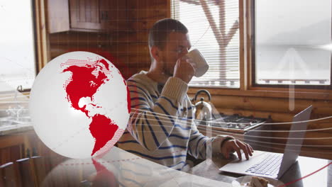 animation of rotating globe, up arrows over caucasian man drinking coffee while working on laptop