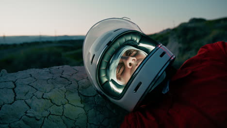 astronaut with helmet sleeps at night in new uninhabited planet