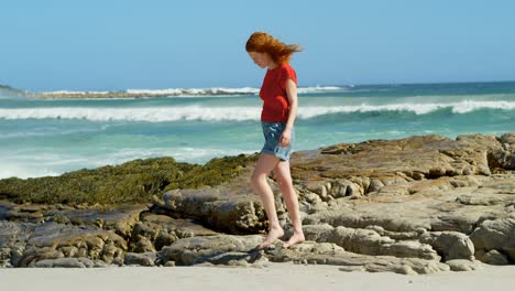 woman walking on the rocky coastline 4k