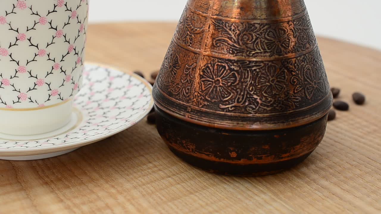 Coffee, coffee cup and grains. Shooting in the movement