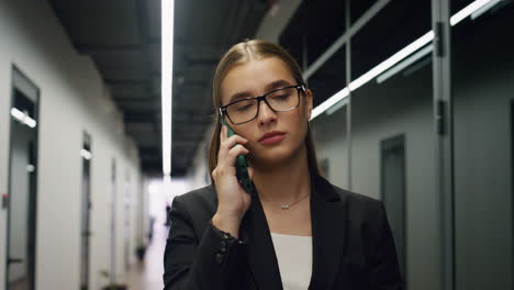 closeup businesswoman talking phone in office. sales manager calling client