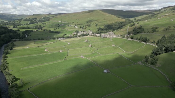 An aerial view of the Yorkshire village of Gunnerside and the surrounding Yorkshire Dales on a sunny summer day, England, UK