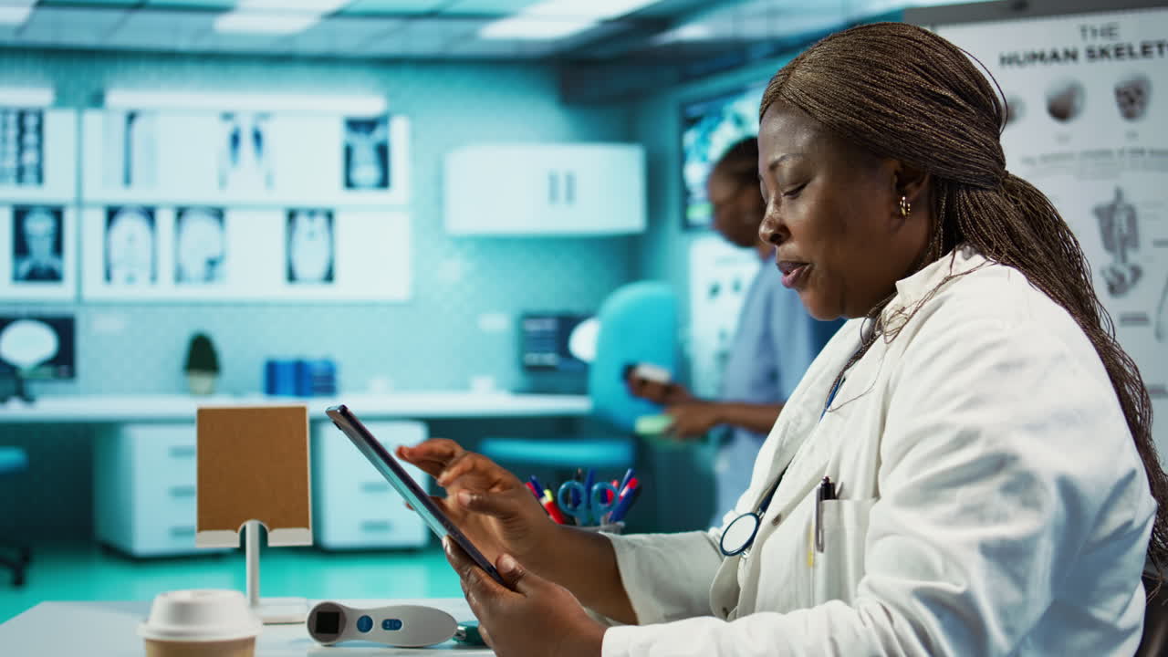 African american specialist reviewing data and records in her office