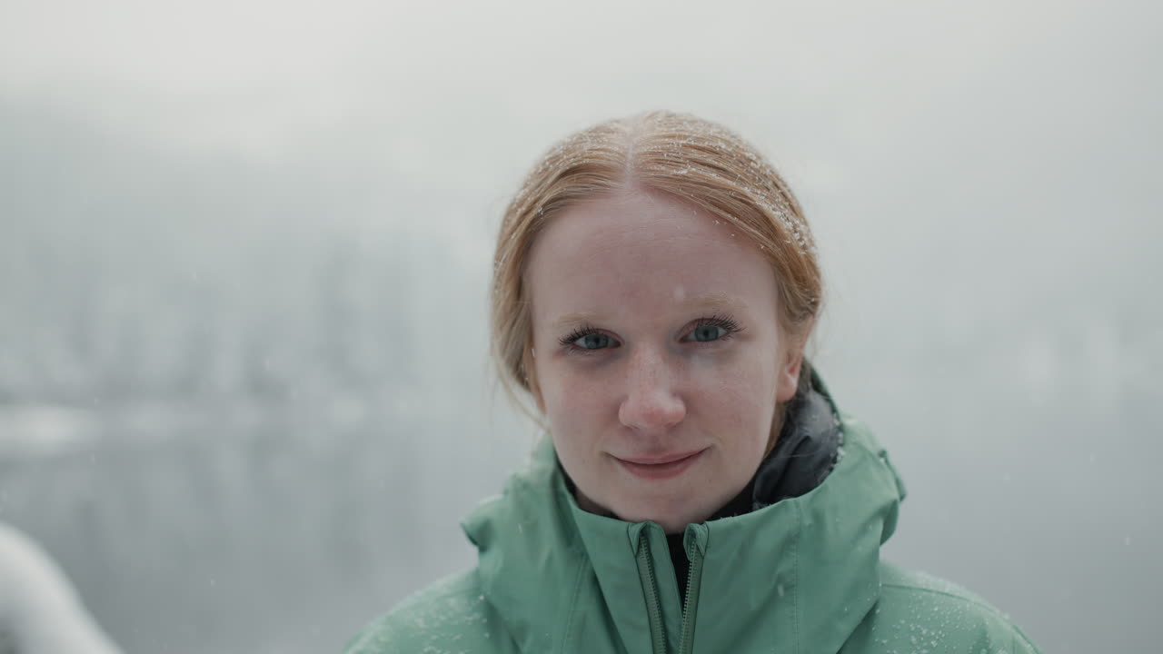 Woman in a Green Jacket in Snowy Weather