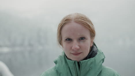 woman in a green jacket in snowy weather