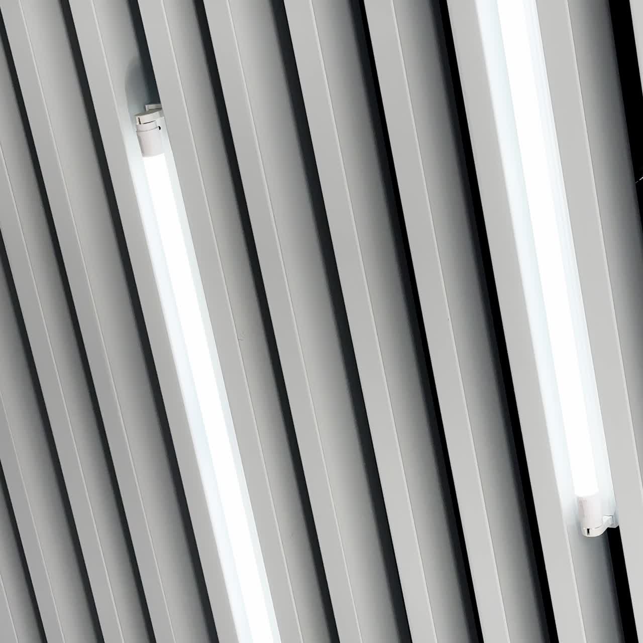 Black and white image of led lamps working on the embossed ceiling. Low angle perspective