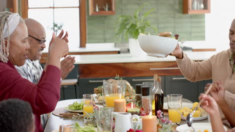 African-american-parents,-children-and-grandparents-celebrating-at-thanksgiving-dinner,-slow-motion