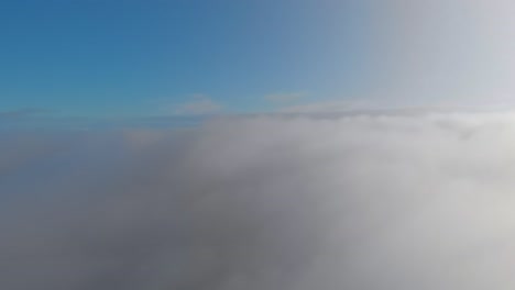 flight above the clouds to the sun, blue sky with fluffy clouds illuminated by the rays of the bright sun. flight on an airplane over white clouds, on vacation on an airplane