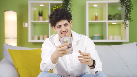 Young-man-counting-his-money-and-kissing-his-money.