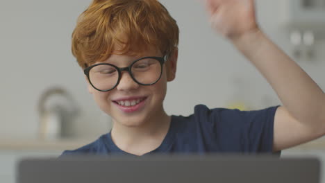 boy waving during a video call