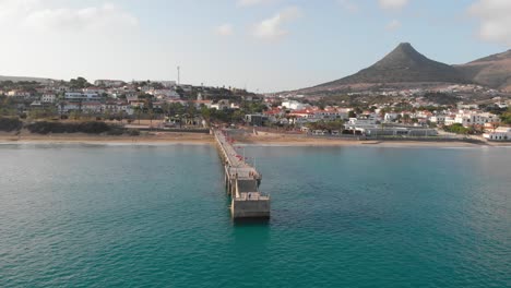 drone flies around a walkway leading out from the island of porto santo