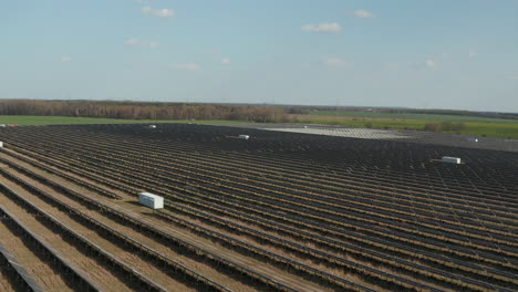 Aerial-view-of-solar-park.-Forwards-fly-above-rows-of-photovoltaic-panels.-Green-energy,-ecology-and-carbon-footprint-reduction-concept