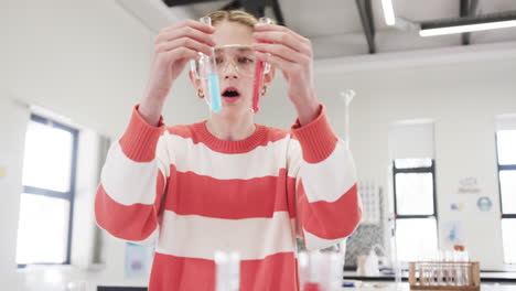Young girl in science lab examining colorful liquids in test tubes, looking curious, at school
