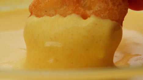 dipping chicken nuggets in sauce