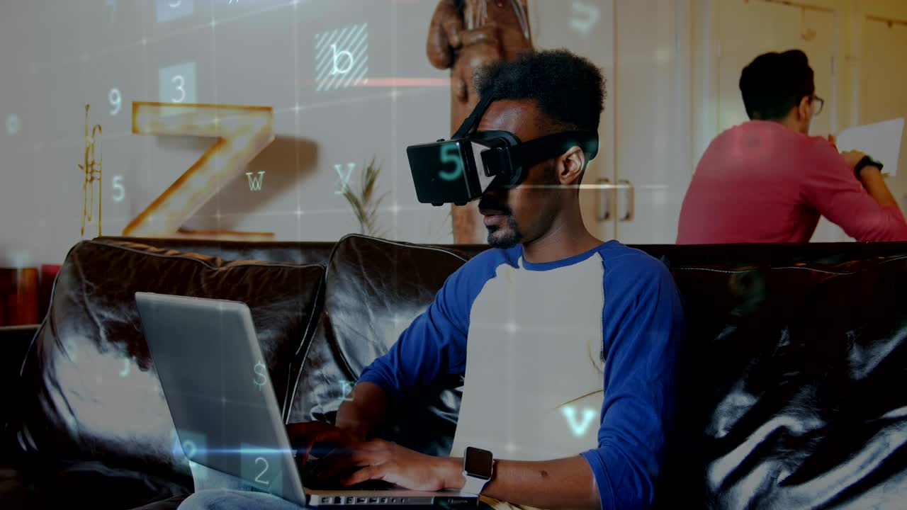 Man wearing a virtual reality headset while typing on his laptop 4k