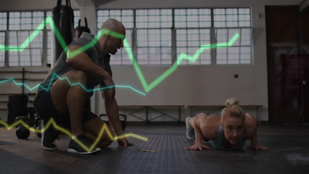After fitness coach aligning hand on gym floor woman doing pushups green graph reflecting effort