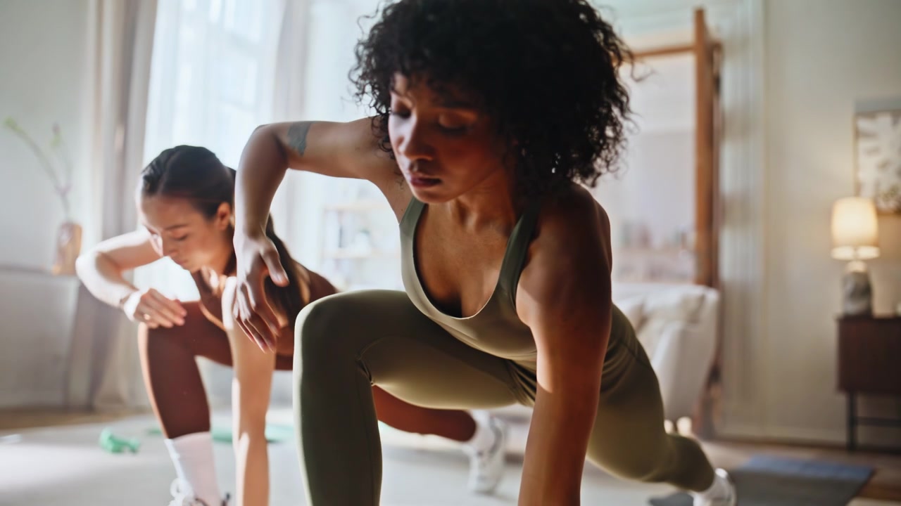 Two women stretching legs together home living room. Fitness partners workout.