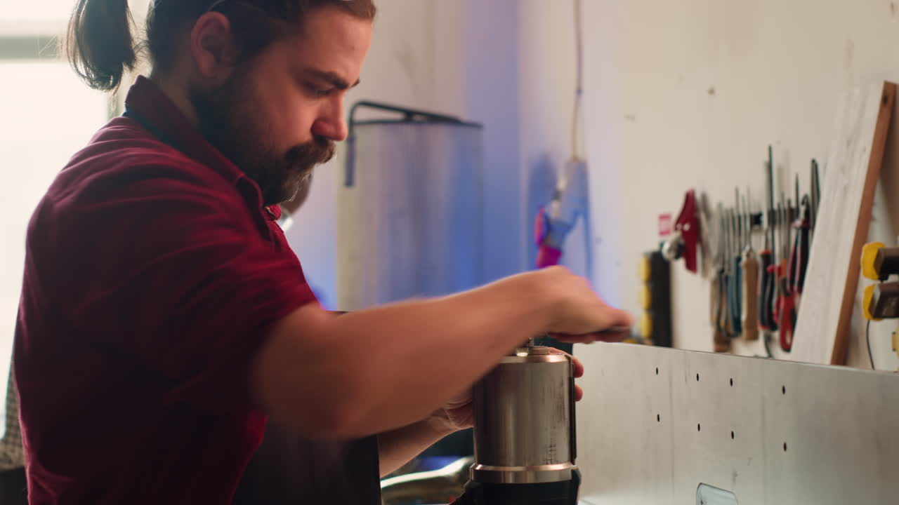 Mechanic in carpentry shop changing rotor part on spindle moulder