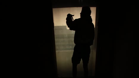 silhouettes of people looking out of a window at night