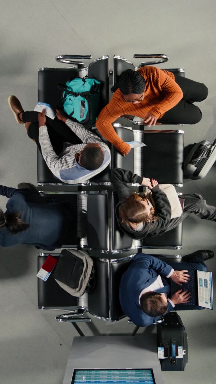 Overhead View of Diverse Travelers Waiting in Airport Lounge
