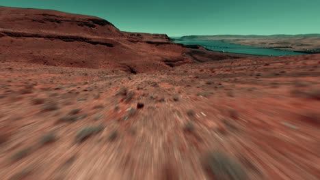 cinematic aerial of a fpv racing drone flying at low altitude in a valley of west coast then rising above a cliff and revealing the highway usa