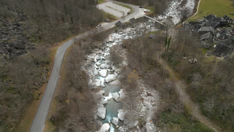 drone flying over the stretch of the river maggia, passing by the village of cavergno, in he district of vallemaggia, in the canton of ticino, in switzerland