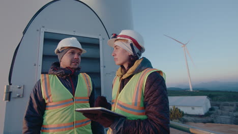 wind turbine service technicians working with digital tablet