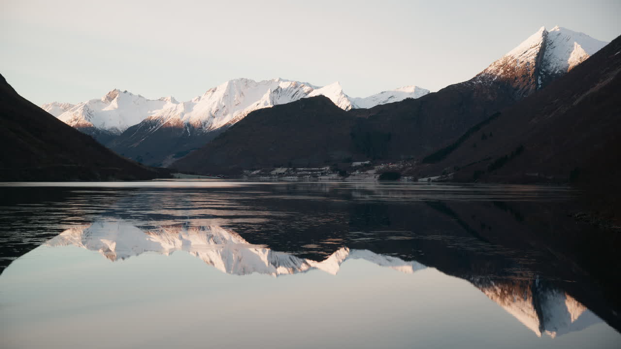 Scenic shot of Norangsfjord, a fjord in Norway with stunning scenery and the fjord reflects the mountains clearly on a cold sunny winter day