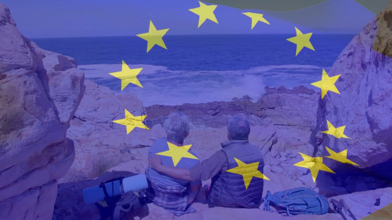 Idosos em viagem sentados na costa observando o mar, homem com o braço em volta da mulher, estrelas amarelas formando um anel sobre eles