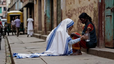 sister of charity helping a homeless woman in india