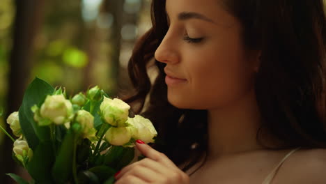 smiling bride admiring flowers