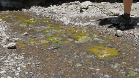 A-woman´s-feet-crossing-a-small-stream