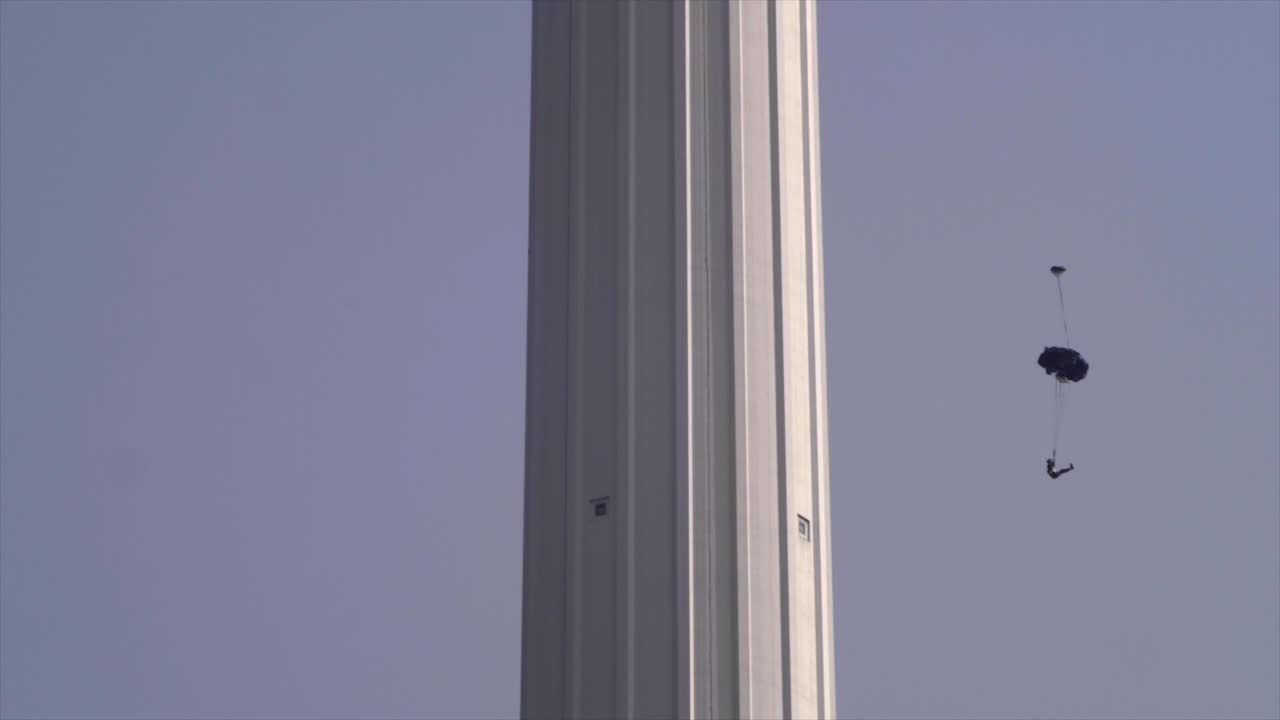 Base jumpers jumping from Menara tower in Kuala Lumpur.
