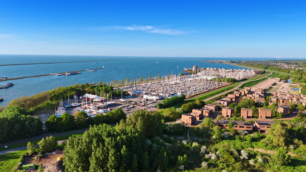 Big yacht club surrounded by lush greenery. Aerial perspective on the lakefront of Merkemeer Lake in Lelystad, the Netherlands.