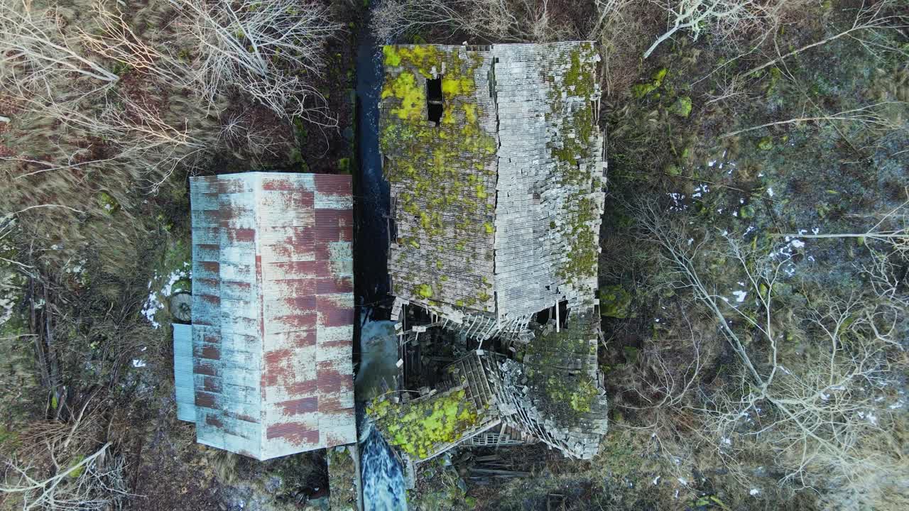 Top down aerial of the collapsed rooftop of an abandoned sawmill in rural Sweden