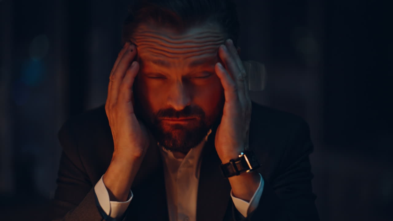 Portrait manager overworking late dark apartment. Exhausted ceo closing laptop